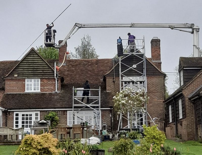 The Roof Moss Cleaners using cherry picker and scaffolding to clean roof safely and professionally in Shefford, Bedfordshire
